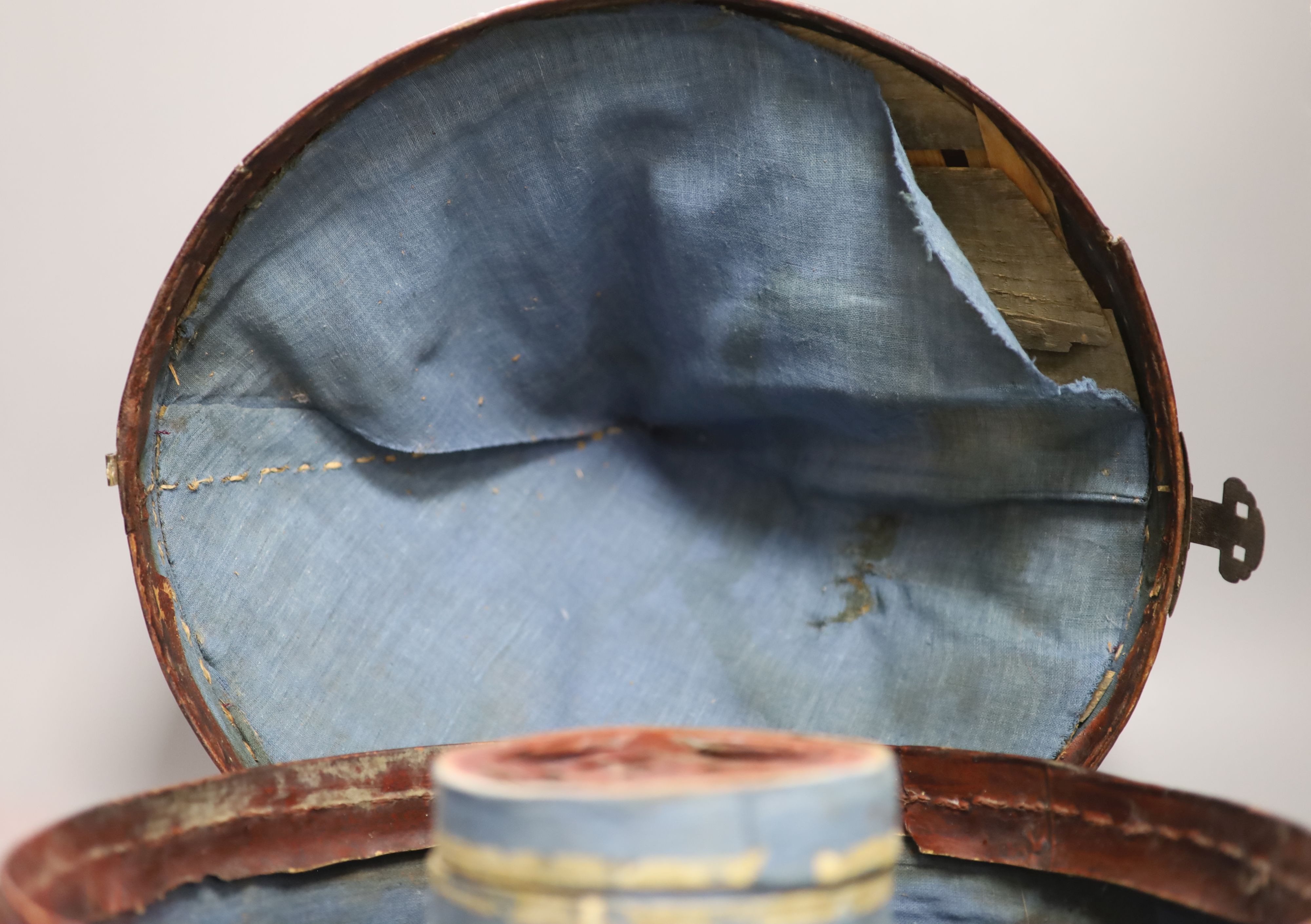 A Chinese late Qing mandarin hat, with gilt finial and original hide case